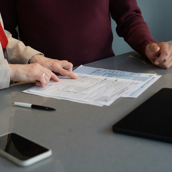 Advisor reviewing financial paperwork with a client at the table